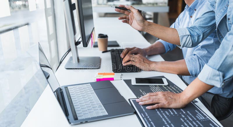 Two professional programmer cooperating and working on web site project in a software developing on desktop computer at company, codes and typing data code, Programming with HTML, PHP and javascript