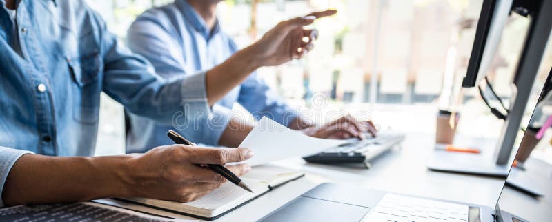 Two professional programmer cooperating and working on web site project in a software developing on desktop computer at company, codes and typing data code, Programming with HTML, PHP and javascript