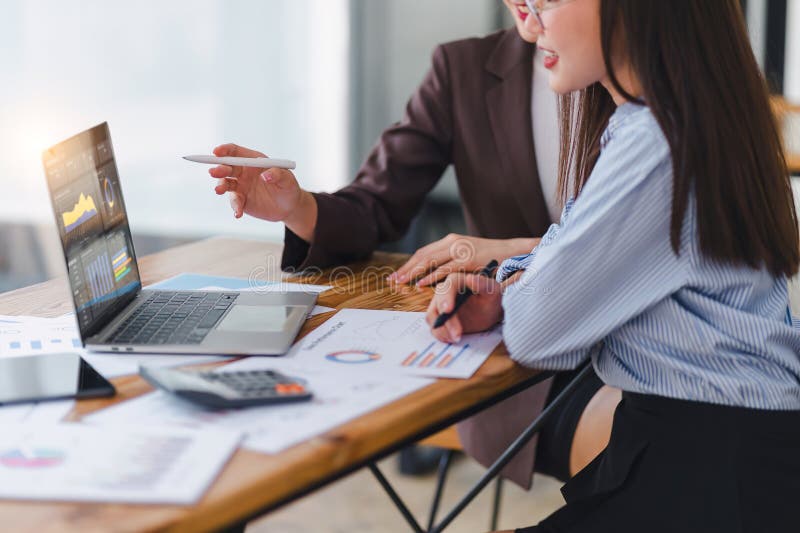 Two professionals analyzing business data on dashboard screen and discussing financial graphs and charts in a modern royalty free stock images