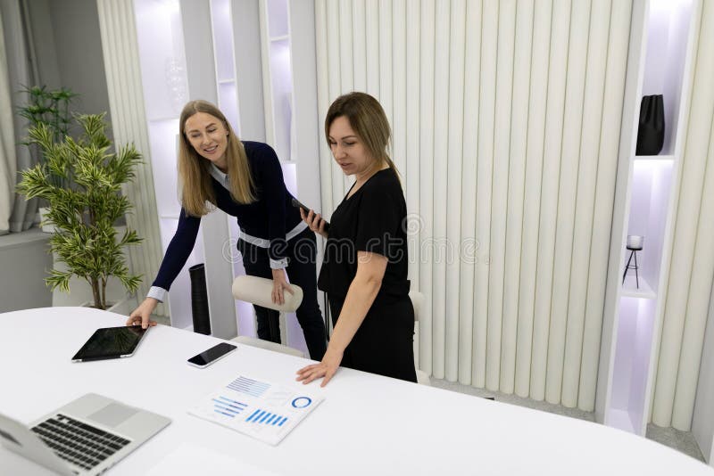 Two professionals collaborating at a modern workspace while discussing project data and insights during the afternoon royalty free stock image