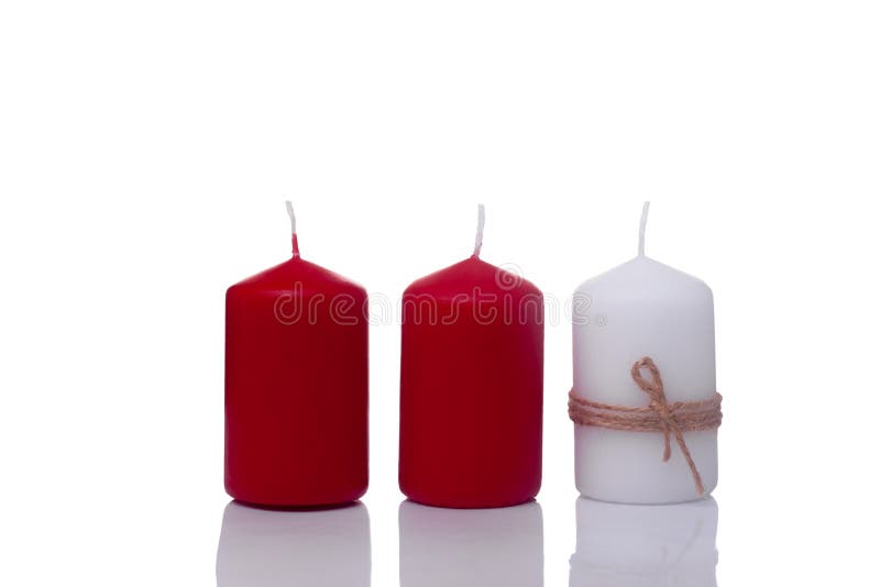 Two Red Candles and One White Candle in a Jute Rope, Isolated on a