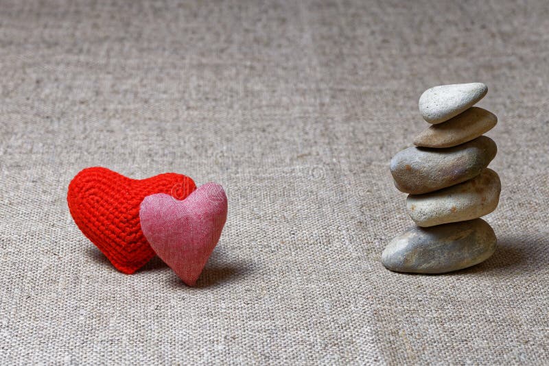 Two red hearts and column of stones