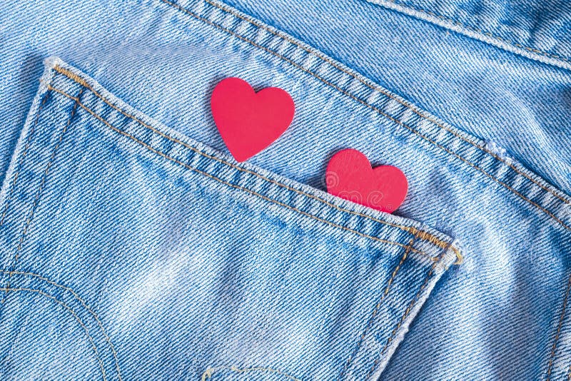 Two red hearts on old denim background. Concept Valentine`s Day