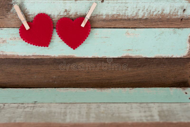 Two red hearts with wood clip