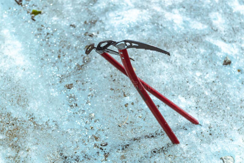 Two Red Ice Tool Crammed into Blue Ice, Ice Axe. Two Mountaineering Ice Axe Crammed into Blue