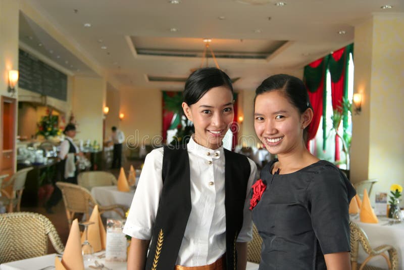 Two restaurant staff at work