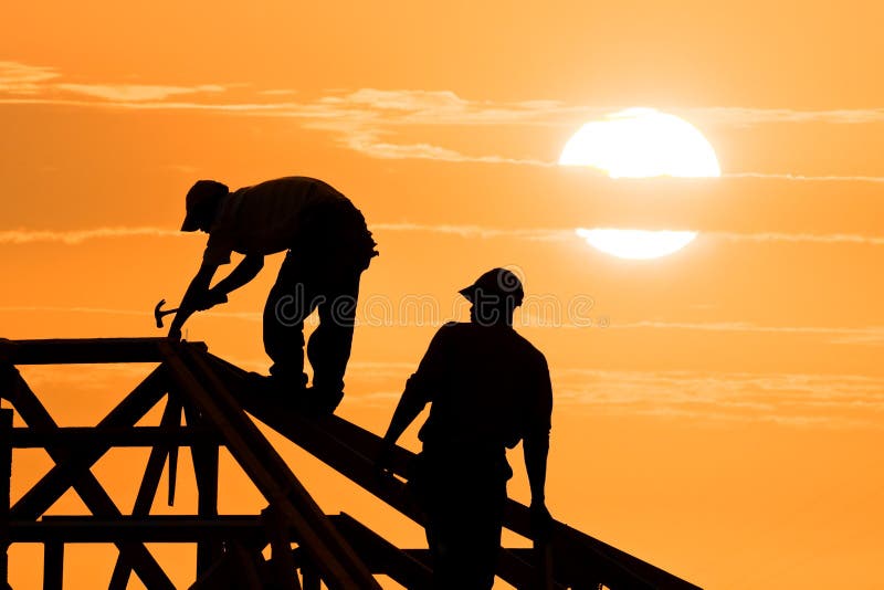 Two Roofer working on roof structure sunflare