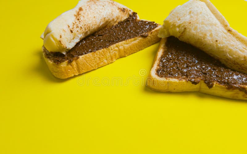 Two Sandwich Toast with Half Chocolate Bread Spread with Yellow Background Stock Photo Image