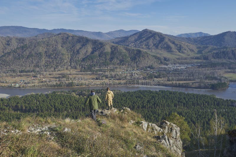 Two scientists standing on top of a hill