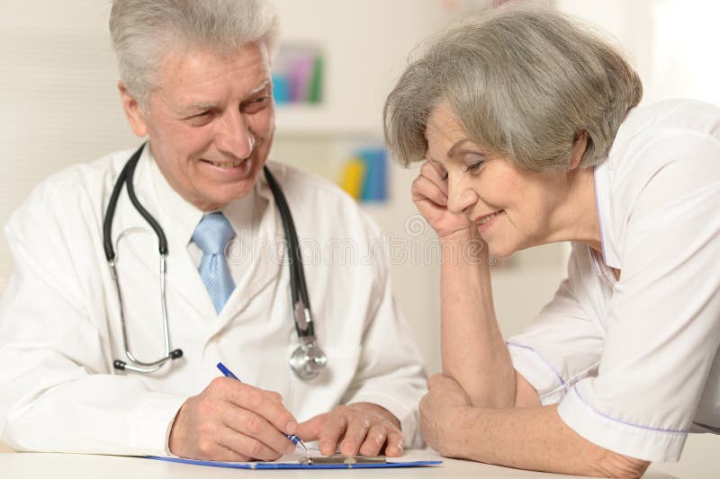 Two senior doctors at table