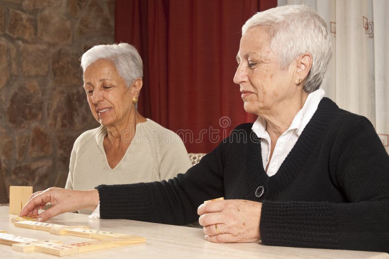 Two Senior Women Playing Dominoes stock photos Two Senior Women Playing Dominoes stock photos