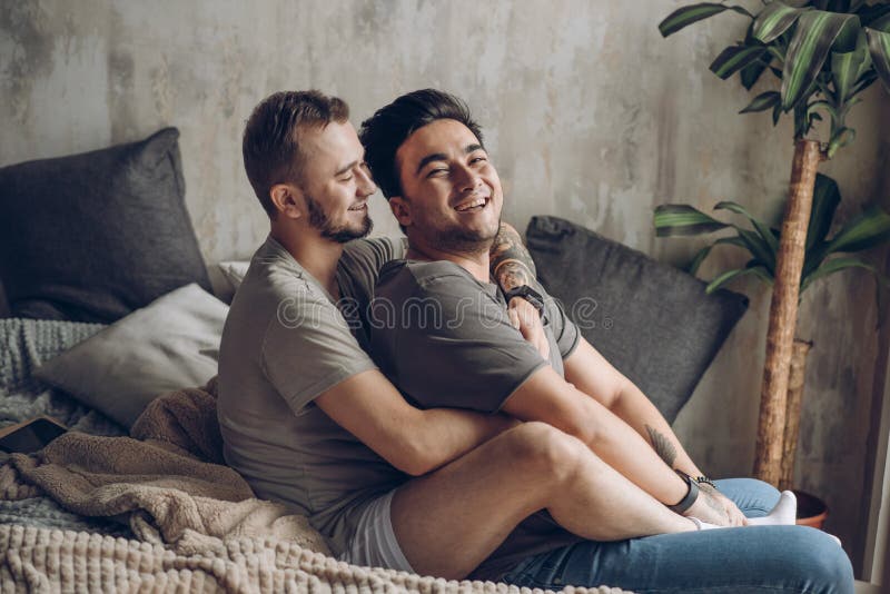 Two Caucasian Gay Guys Hugging and Having Fun in Bed Indoors Stock Image