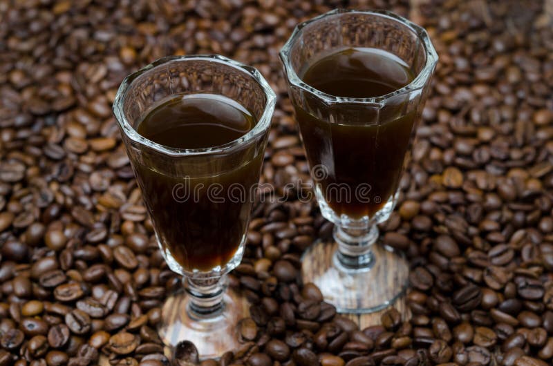 Two shot glasses of coffee liqueur, selective focus