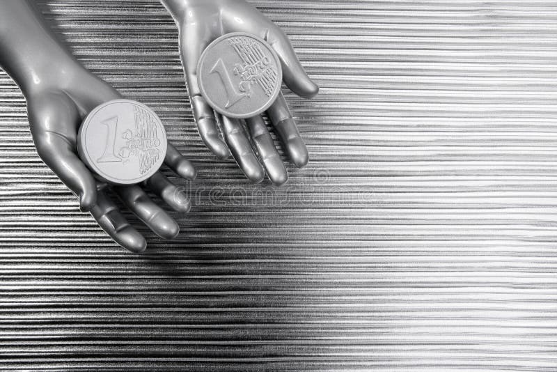 Two silver euro coins in futuristic robot hands