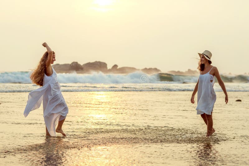 Two Sisters Having Fun at the Sea at the Sunset Stock Image - Image of ...