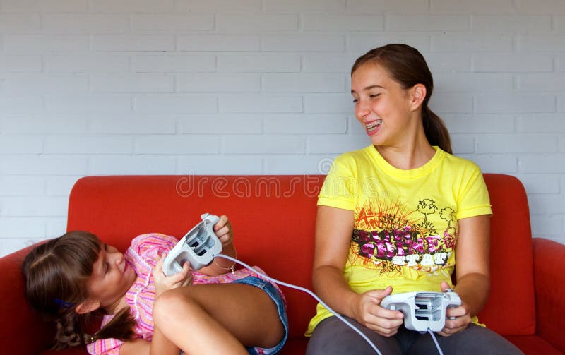 Two Sisters laughing, playing video games