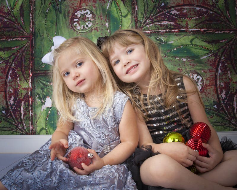 Two Sisters Posing for Christmas Pictures stock photos Two Sisters Posing for Christmas Pictures stock photos