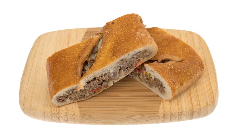 Two slices of a baked steak stromboli