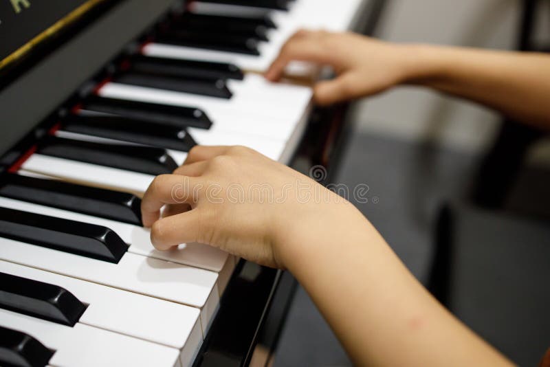 Two Small Childent`s Hands Playing The Piano stock photos Two Small Childent`s Hands Playing The Piano stock photos