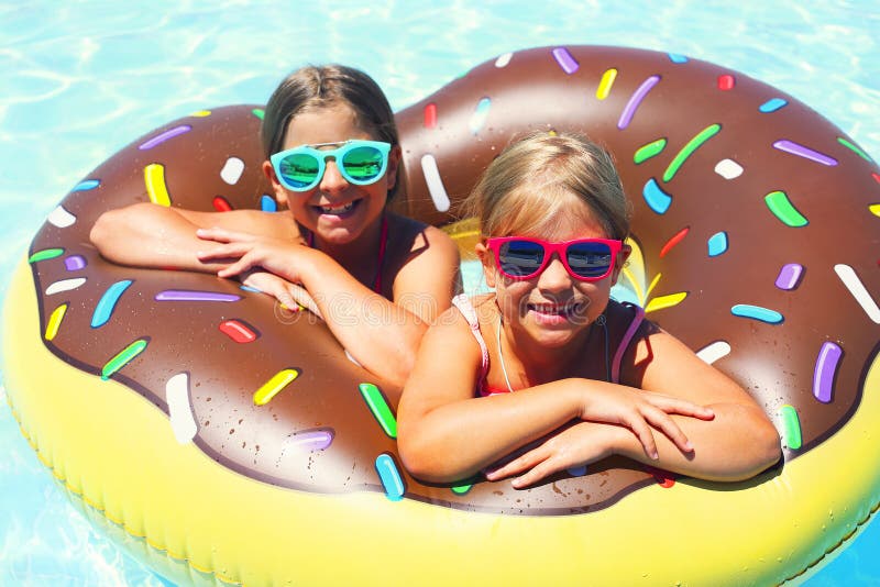Two small girls having fun in pool