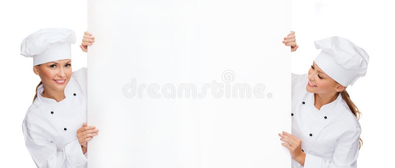 Two smiling female chefs with white blank board royalty free stock photos Two smiling female chefs with white blank board royalty free stock photos