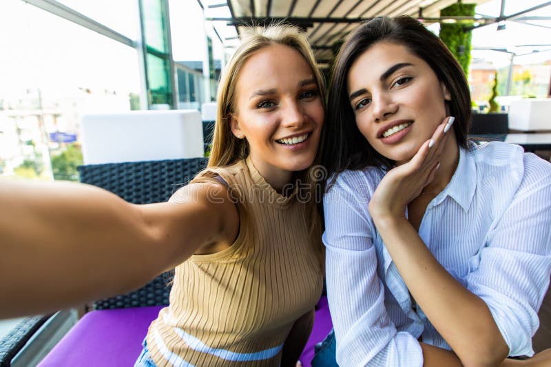 Two Smiling Women Friends Driniking Coffee and Taking Selfie ...