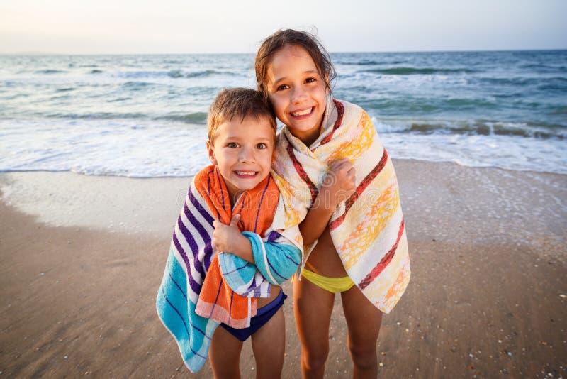 Two smiling kids on the beach