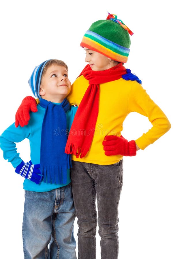 Two smiling kids in winter clothes standing together stock photos Two smiling kids in winter clothes standing together stock photos