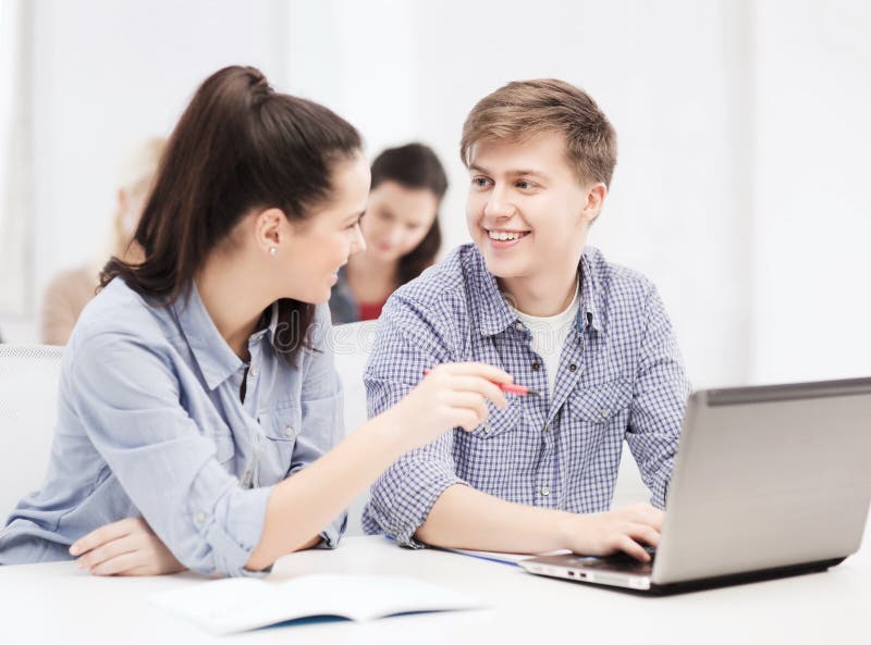 Two smiling students with laptop computer stock photo