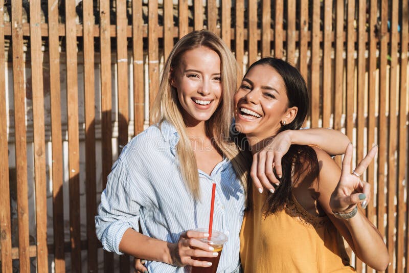 Two Smiling Young Girls Laughing while Standing Outdoors Stock Photo ...