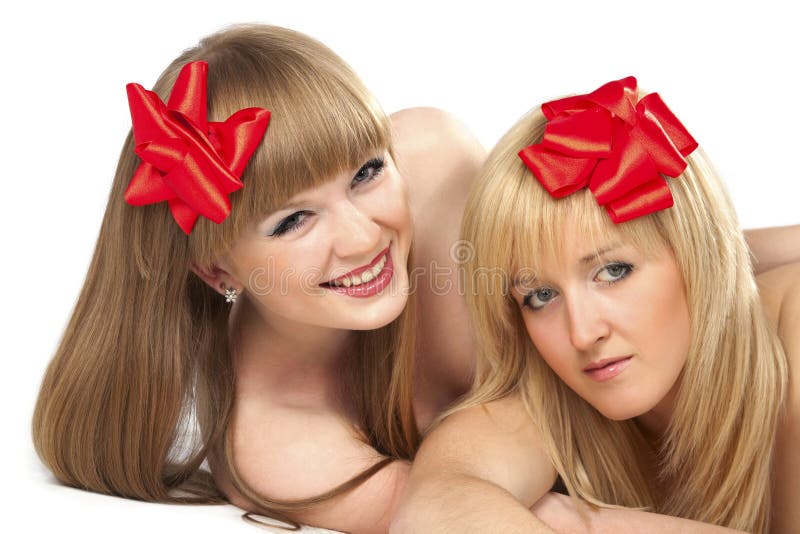 Two smiling young women with gift red bow