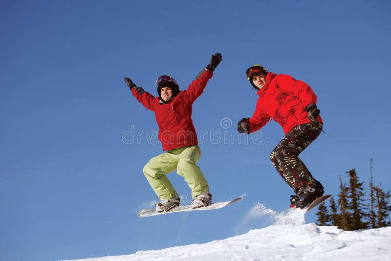 Two snowboarder jumping