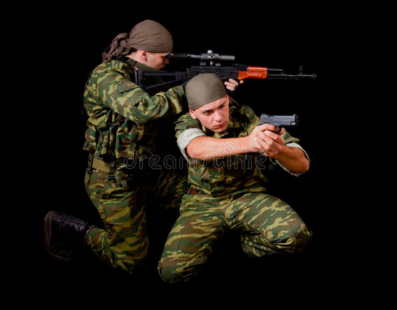 Two soldiers in camouflage uniform with weapon