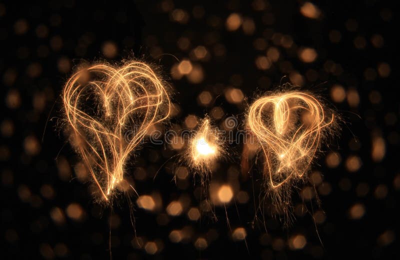 Two sparkler hearts at night