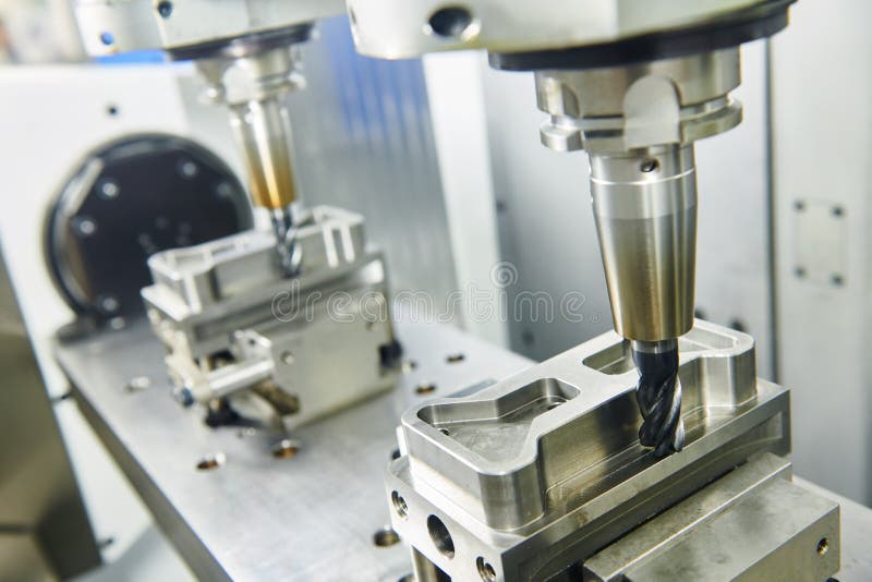 Two spindel CNC milling machine at simultaneous metal working royalty free stock photo