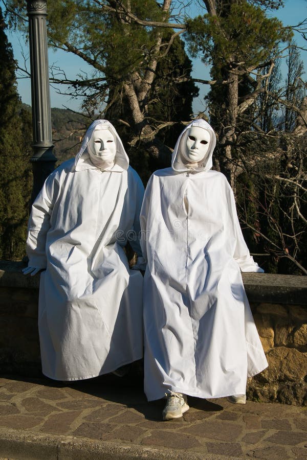 Two spooky white ghost with black eyes sitting in the wall of Castiglion Fibocchi stock photos Two spooky white ghost with black eyes sitting in the wall of Castiglion Fibocchi stock photos