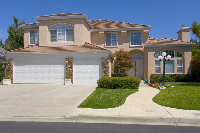 Two Story Stucco Home With A Street Light