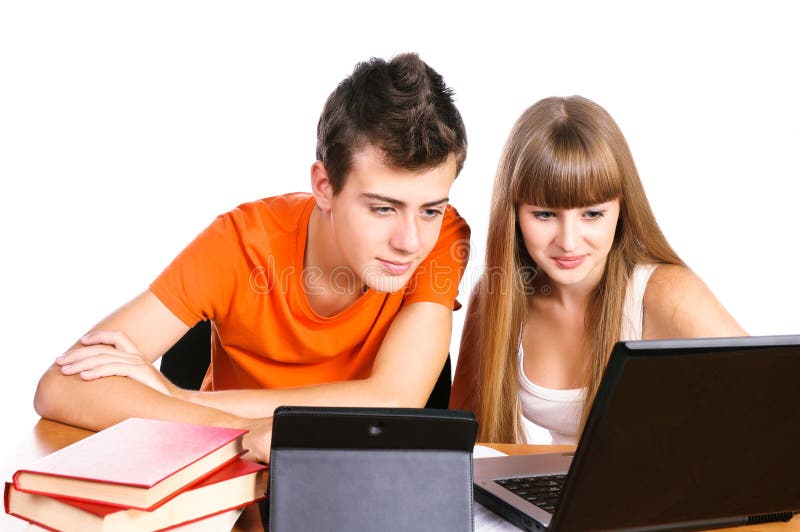 Two students learning with books and laptop