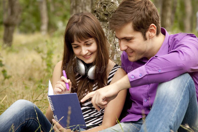 Two students at outdoor doing homework