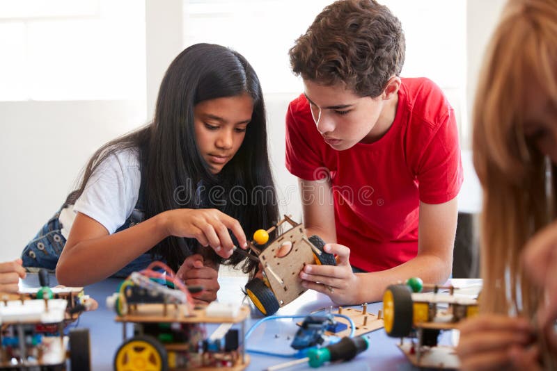 Two Students In After School Computer Coding Class Building And Learning To Program Robot Vehicle royalty free stock photos
