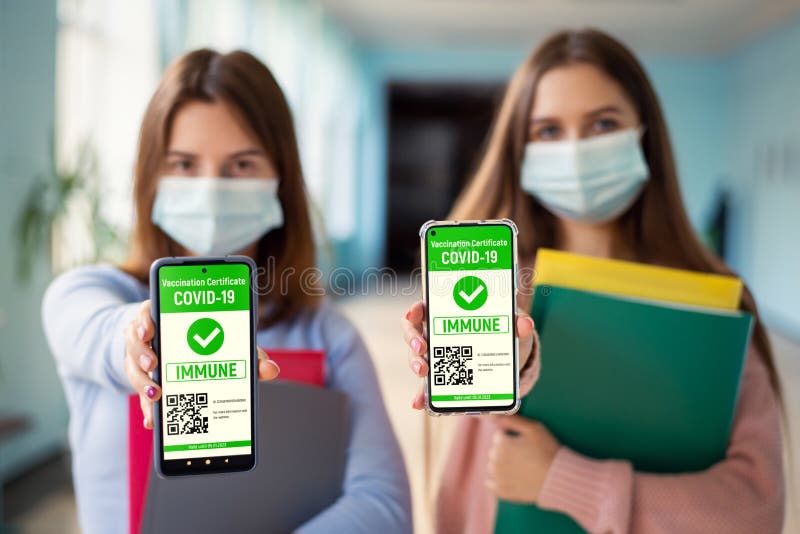 Vaccination among students concept. Two students showing screens of phones with digital certificates of successful vaccination royalty free stock photography Vaccination among students concept. Two students showing screens of phones with digital certificates of successful vaccination royalty free stock photography