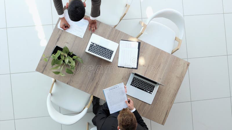 Two successful smiling businessmen are working on a laptop. view from above royalty free stock image