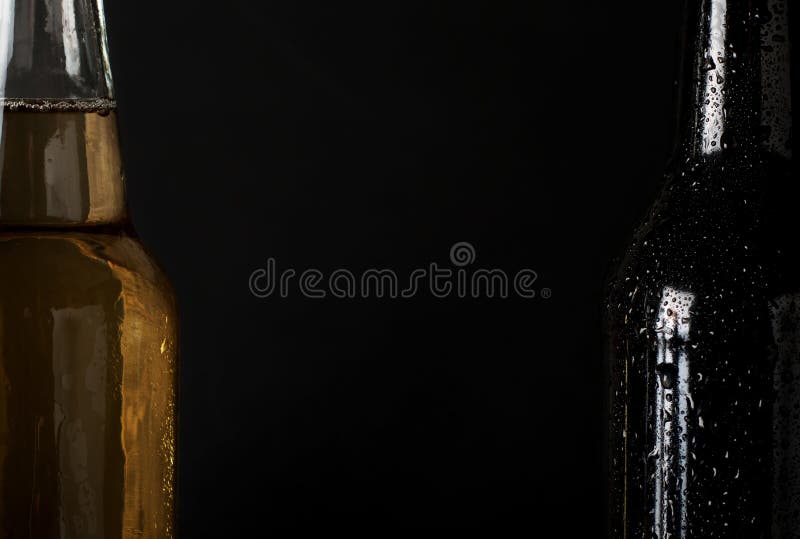 Sweating, Cold Bottle of Beer Closeup on Dark Wooden Background Stock