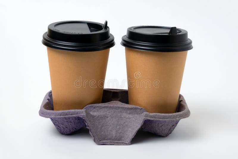 Takeaway paper cups with black plastic lids in cardboard coffee holder isolated on white background royalty free stock photos