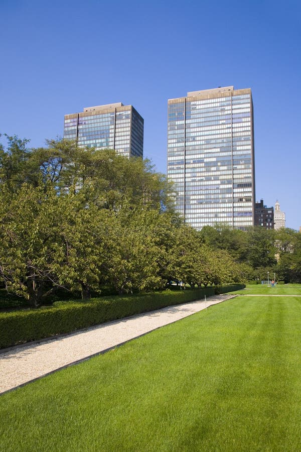 Two tall buildings and a park