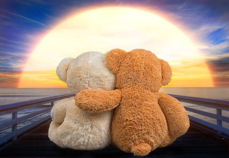 Two Teddy Bear Sitting On The Bridge Near The River And Watch The