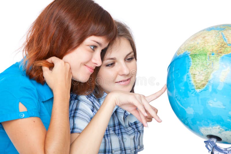 Two teen-girls are looking at globe