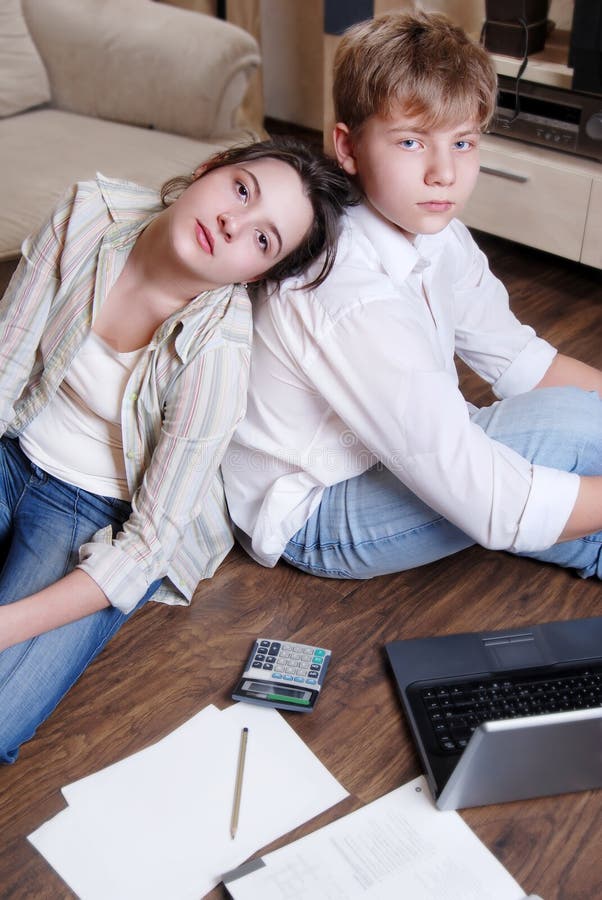 Two teenagers are tired doing their lessons stock photos