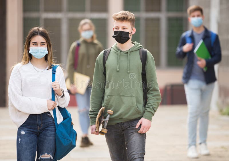 Two Teens in Protective Masks Walk Along Street Stock Image - Image of ...