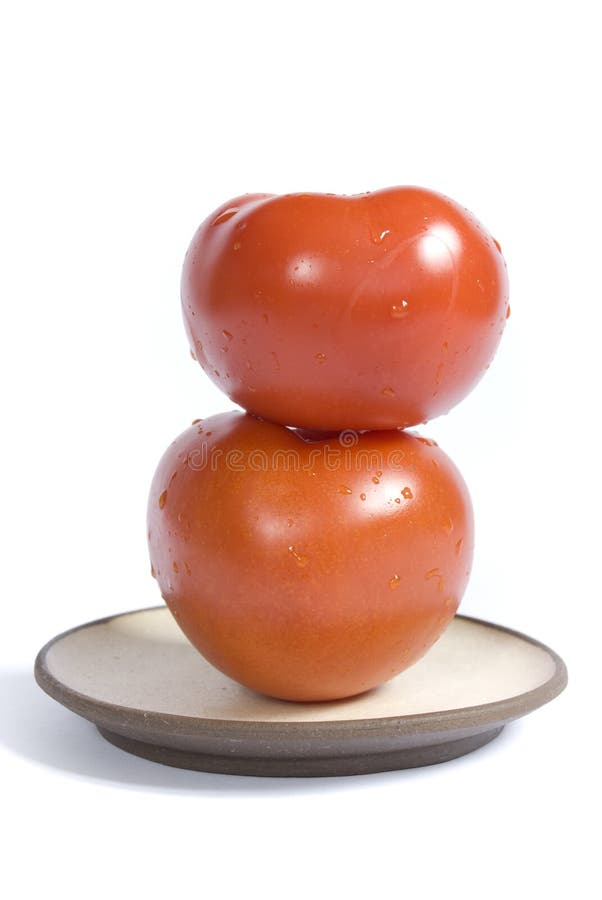 Two tomatoes on a plate